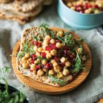 Chickpea flatbread sandwiches with arugula pomegranate and chili crisp