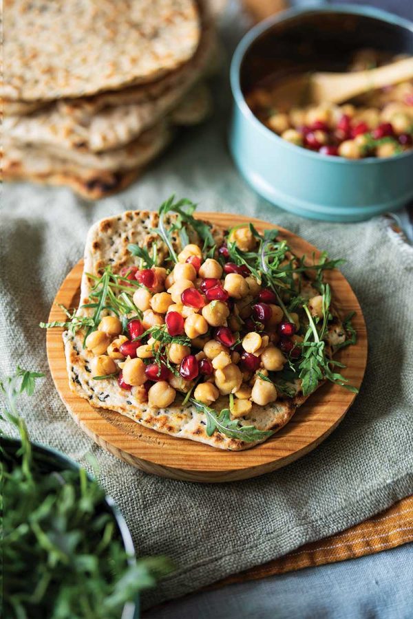 Chickpea flatbread sandwiches with arugula pomegranate and chili crisp
